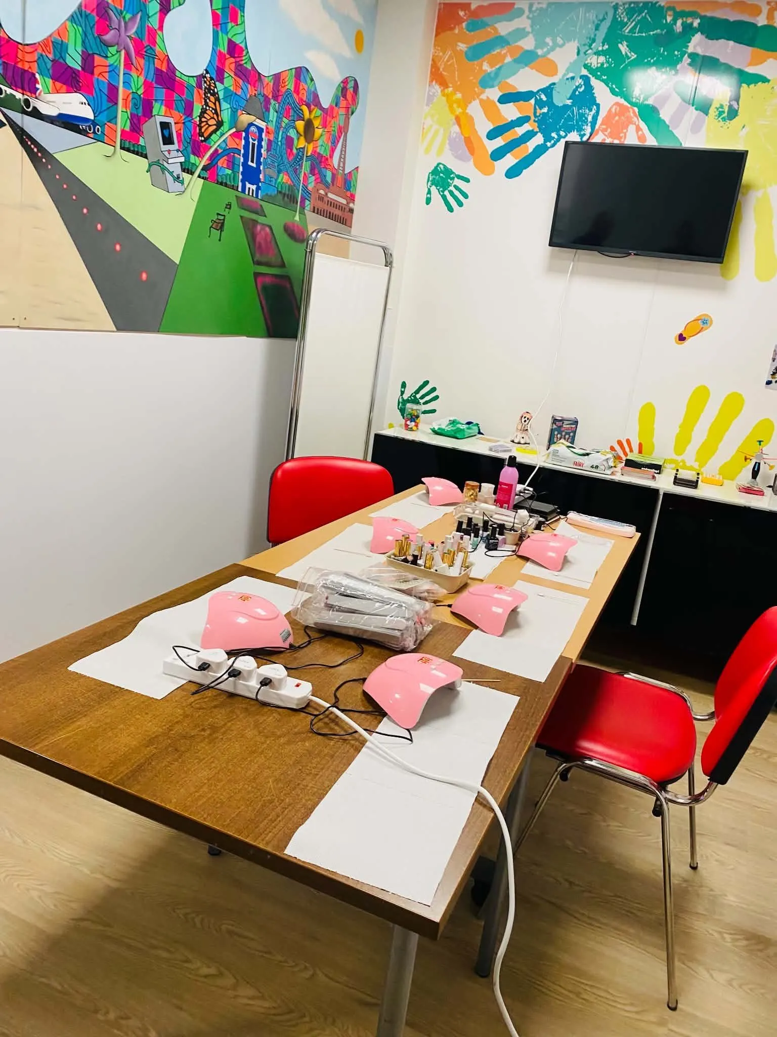 Learning space at The Christie NHS Foundation Trust set up with nail lamps, materials and chairs for a practical session